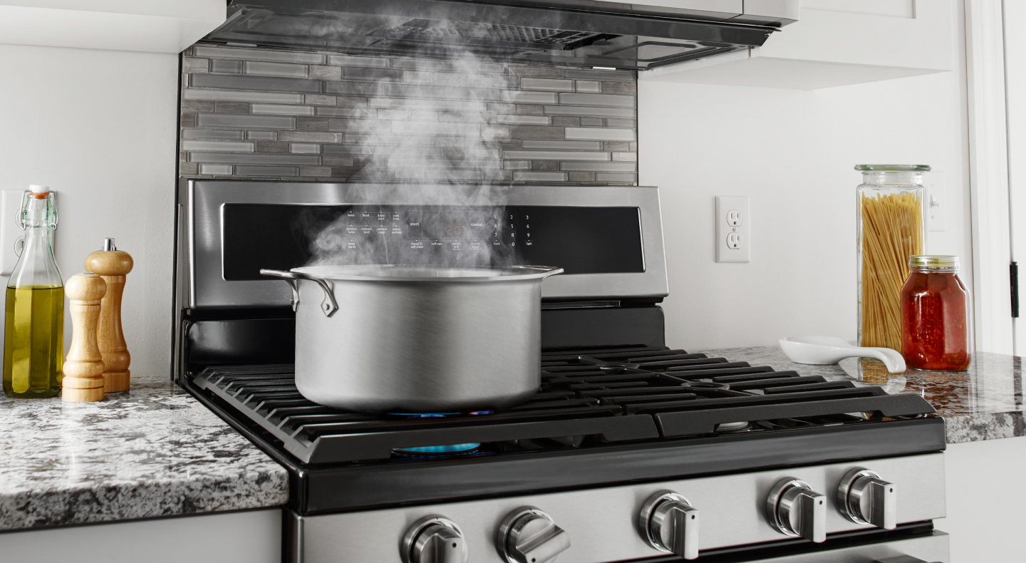 A pot of simmering water on a stovetop