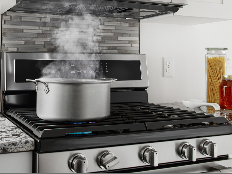 A pot of simmering water on a stovetop
