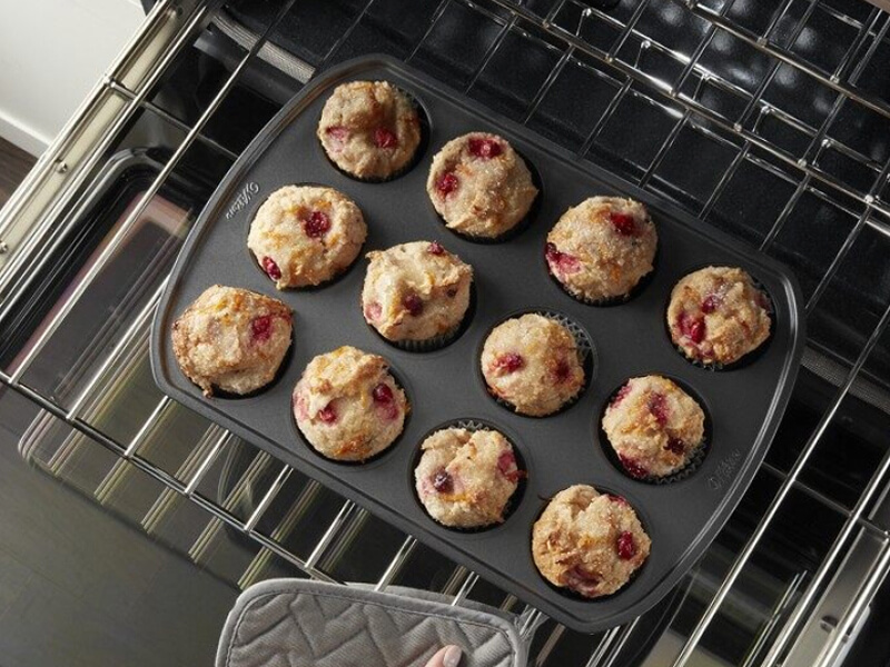 Rack of muffins going into the oven