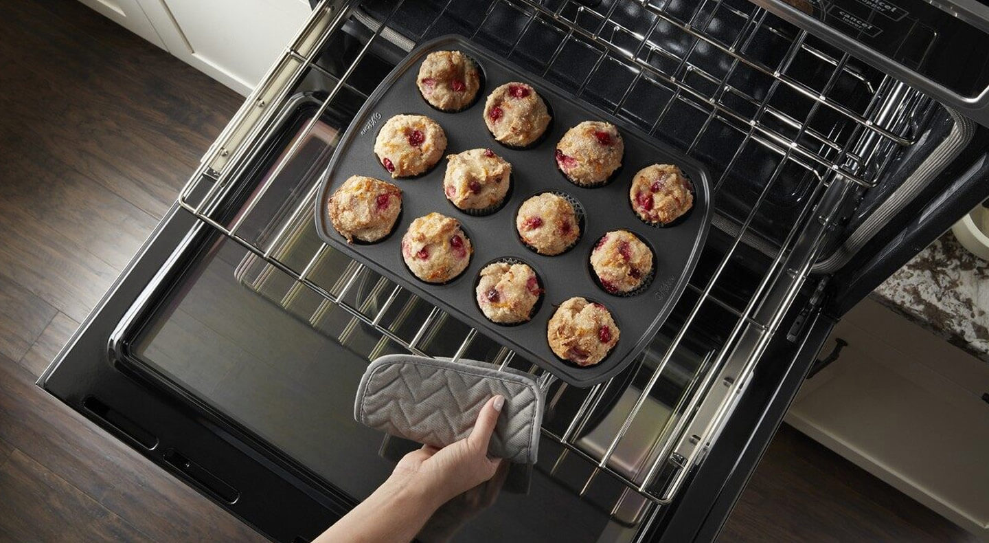 Rack of muffins going into the oven