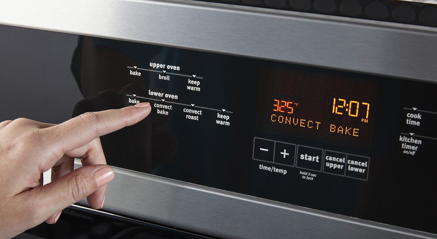Person selecting an option on a wall oven console