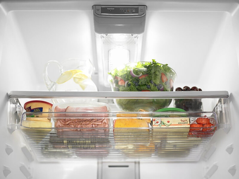 Produce, cheese, raw meat and dips inside a refrigerator