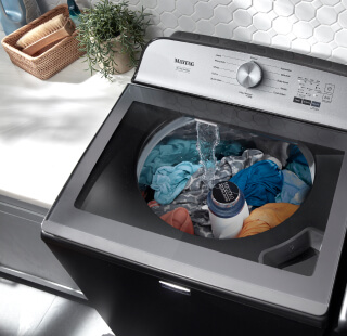 Clothes soaking in a Maytag® washer