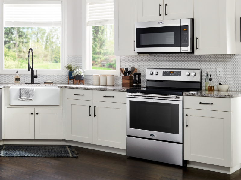 Maytag® microwave hood combination over Maytag® range in white kitchen