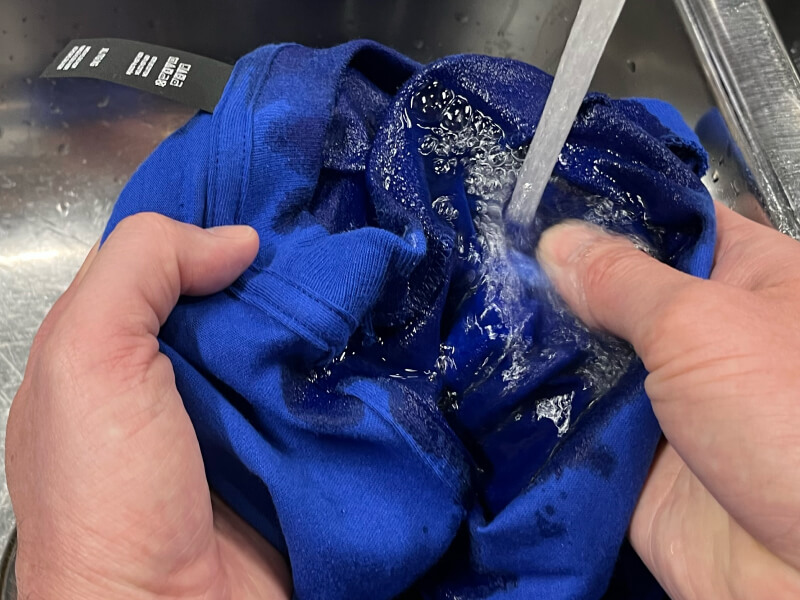 Person rinsing a stain