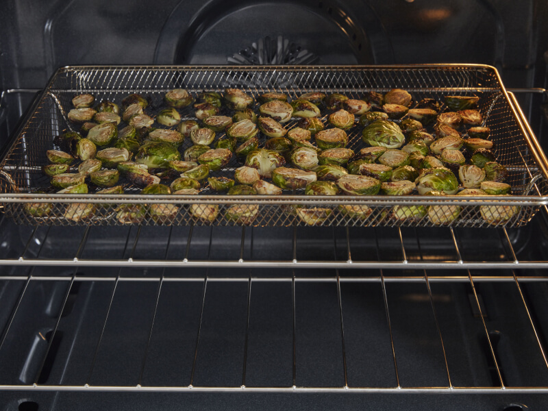 Brussel sprouts cooking in an air frying oven