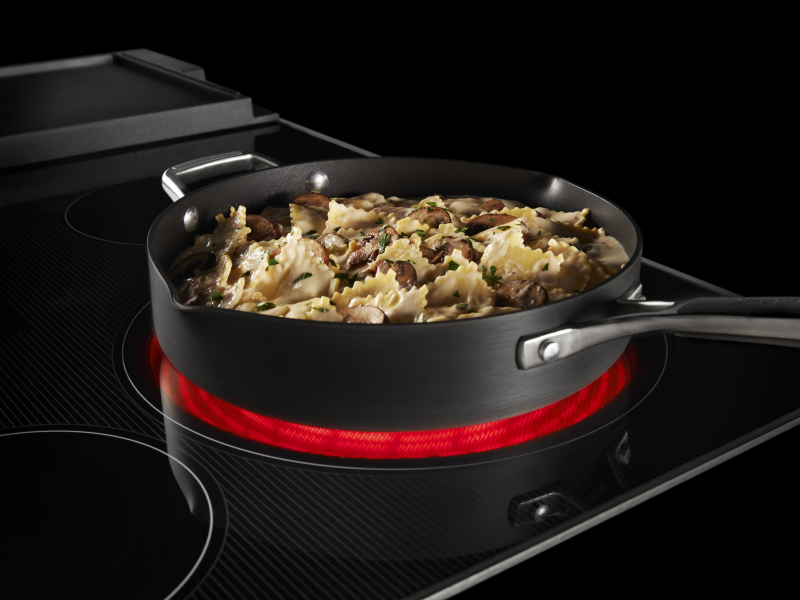 A pasta dish cooking on a heating element