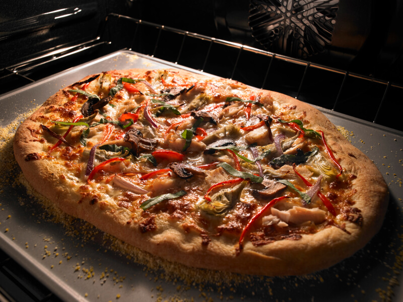 Pizza cooking inside an oven