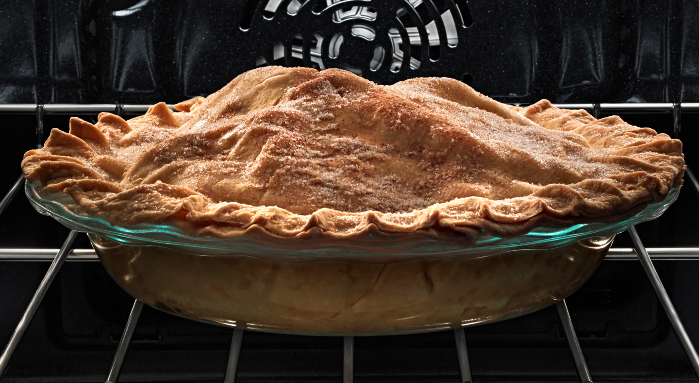  A pie with a golden crust on an oven rack