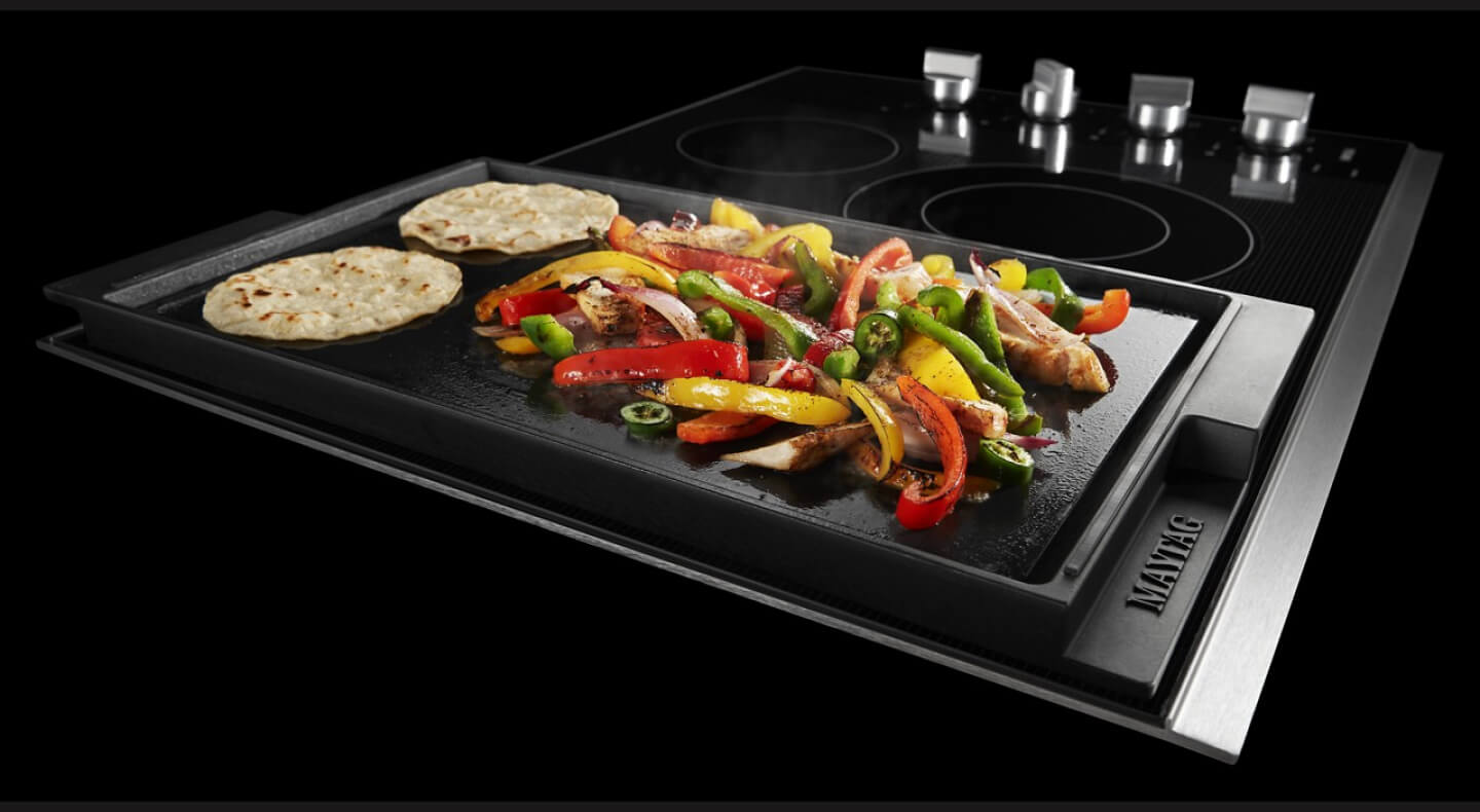 Vegetables and tortillas cooking on a Maytag® griddle