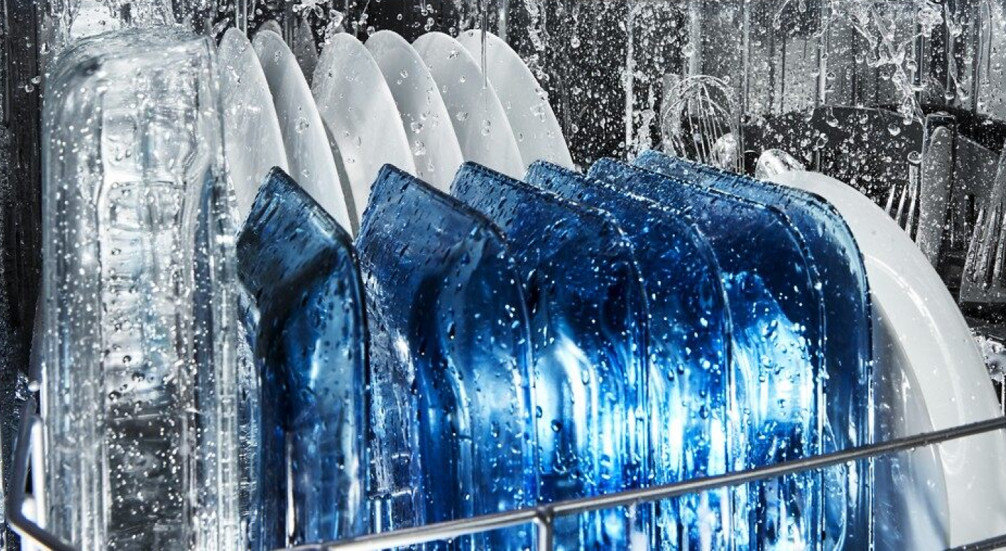Dishes being washed on the bottom rack