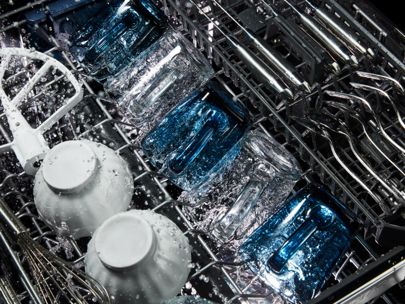 Dishes being washed inside a dishwasher