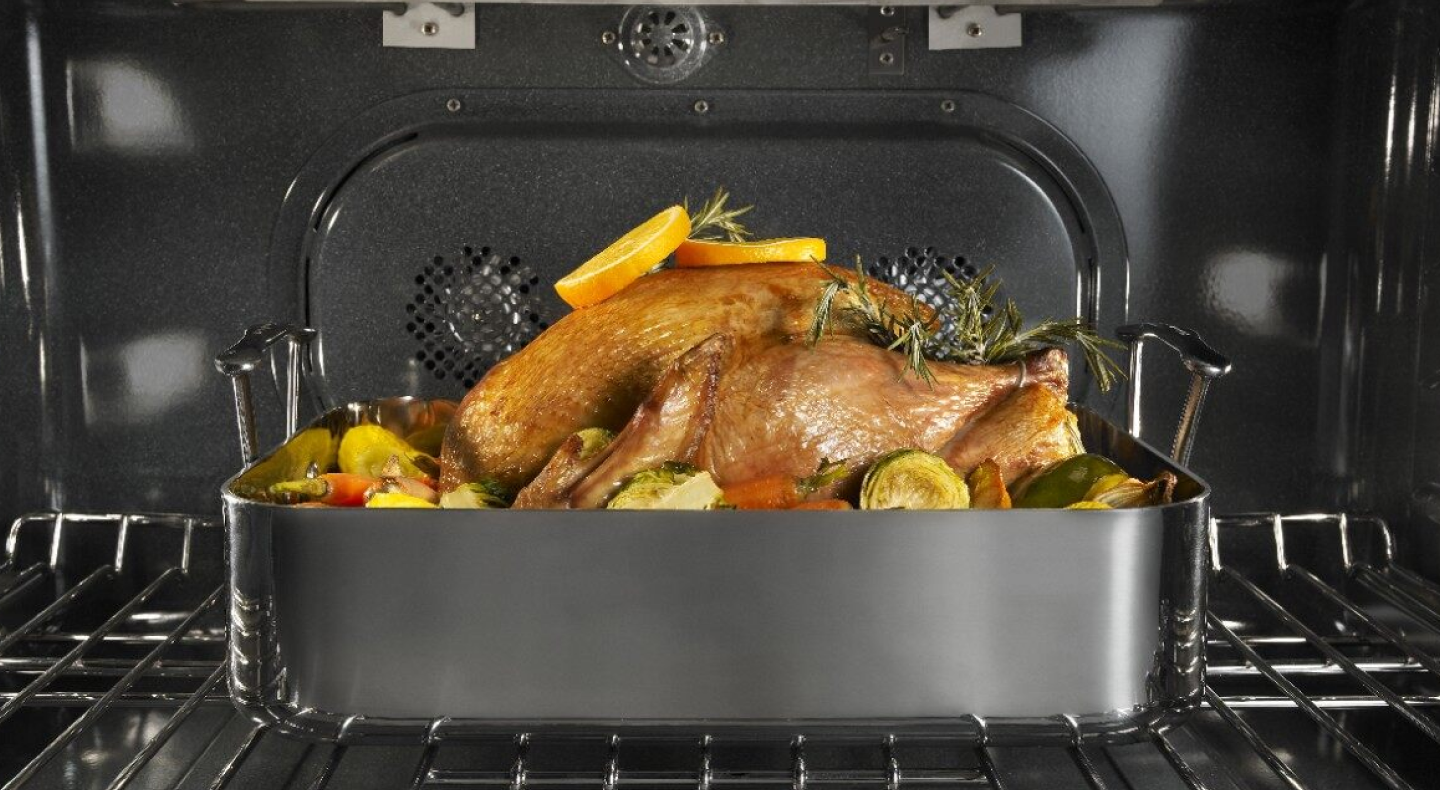 Turkey in the oven garnished with citrus and herbs