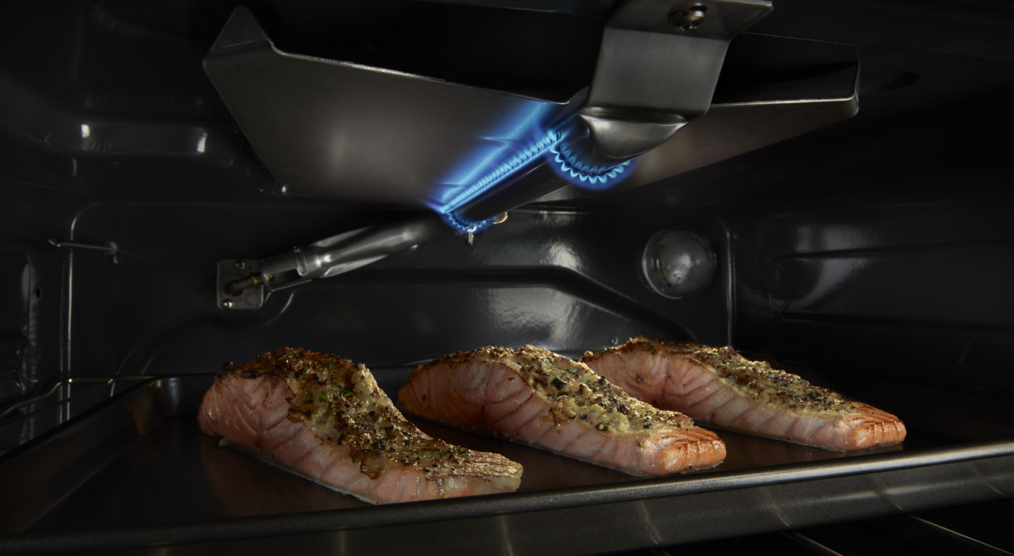 Three salmon filets cooking inside a Maytag® oven