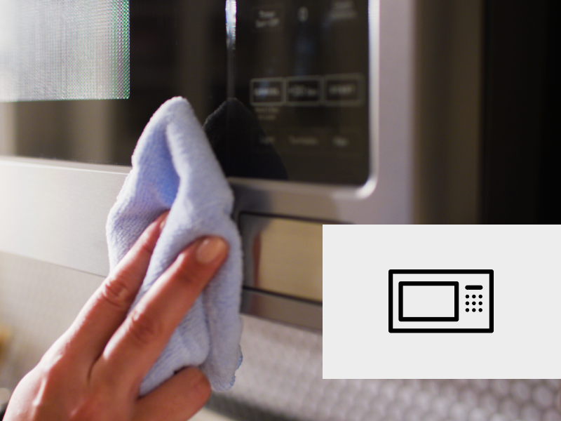 Cleaning the exterior of a microwave.