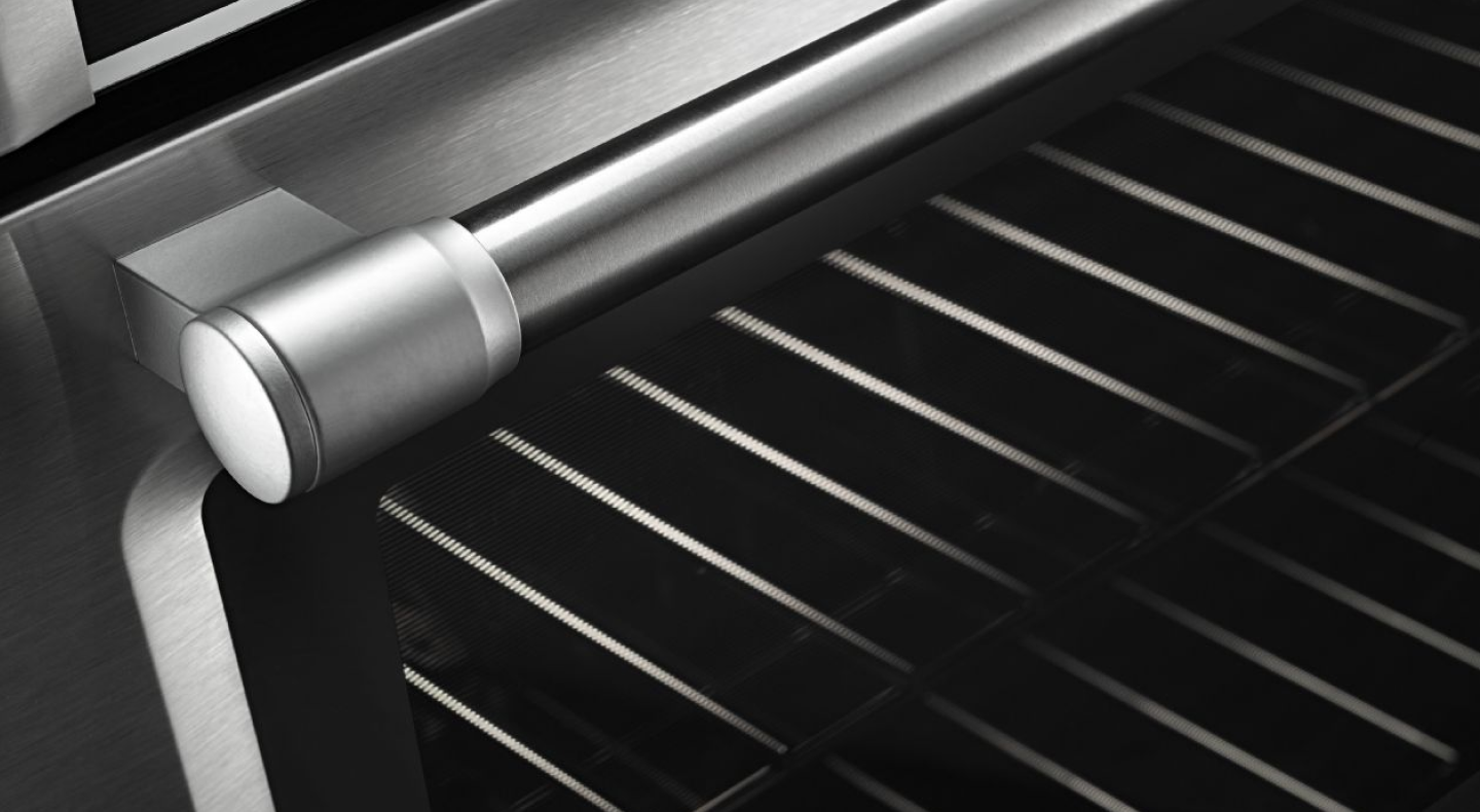 Two oven racks as seen through a glass oven door.