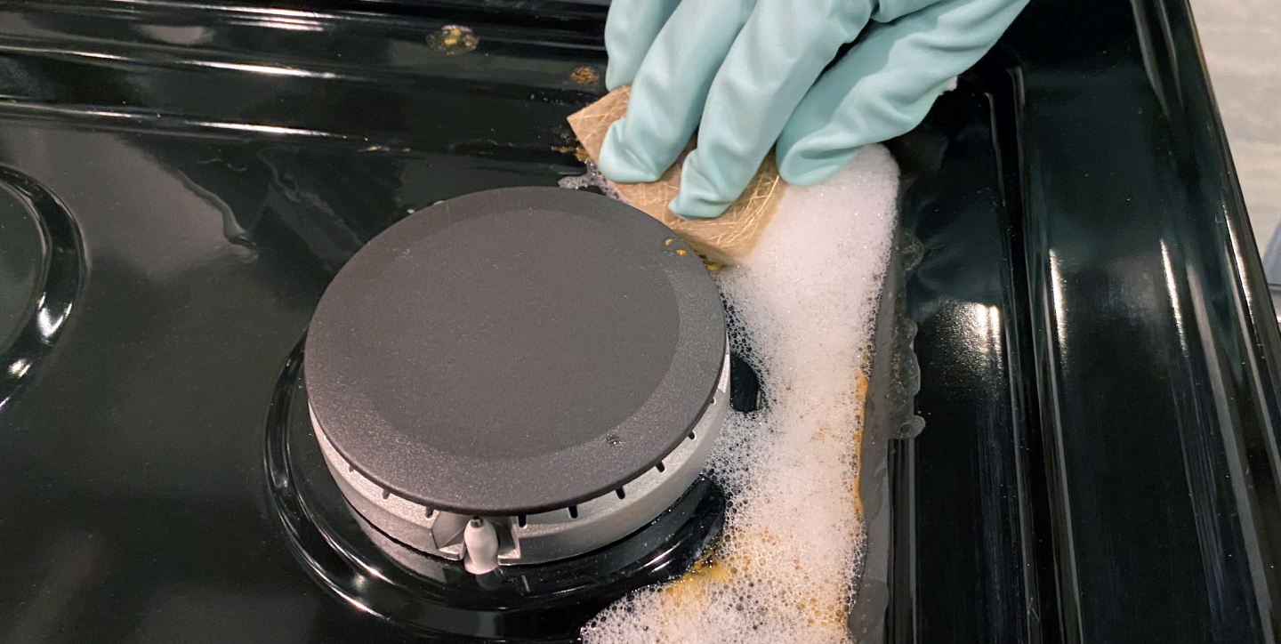 Removing grease from stovetop with soapy water