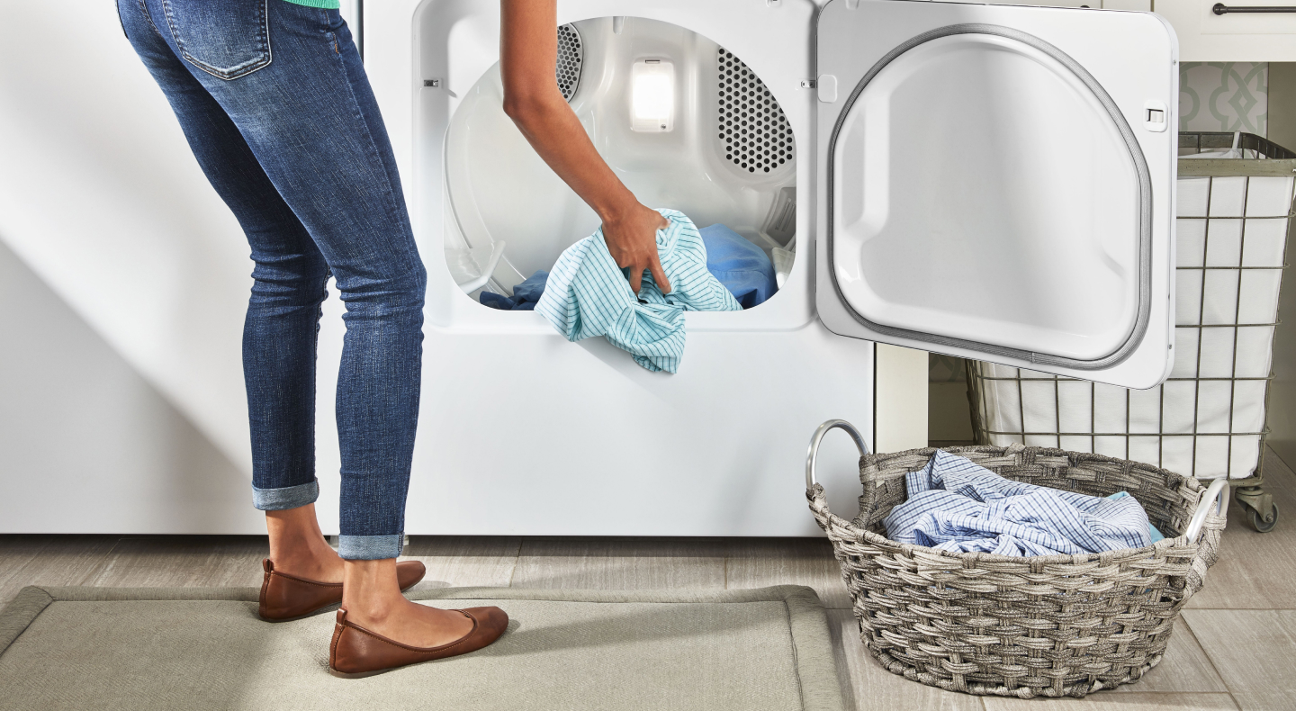 Person placing laundry in a laundry basket