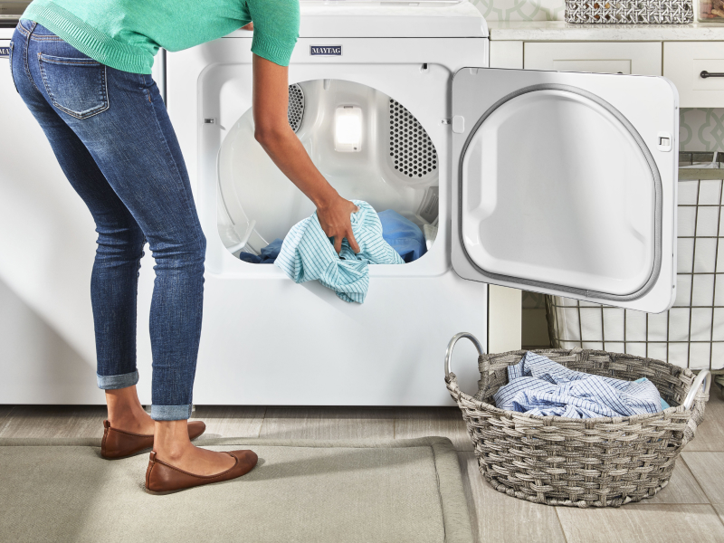 Person placing laundry in a laundry basket