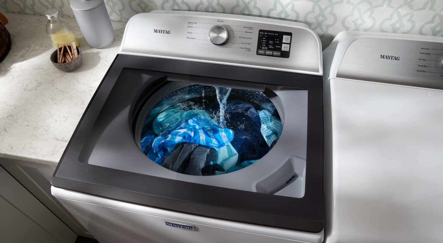 Clothes being washed in a top load washing machine