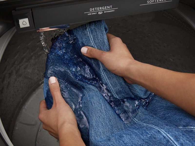 Hands pretreating denim with a built-in faucet