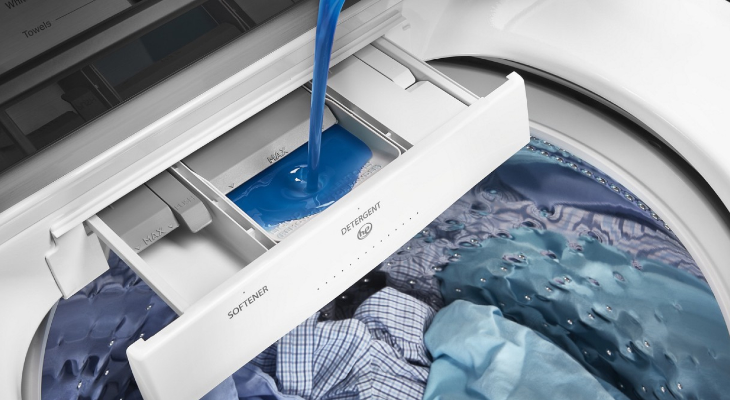 Detergent being poured into a washer detergent dispenser