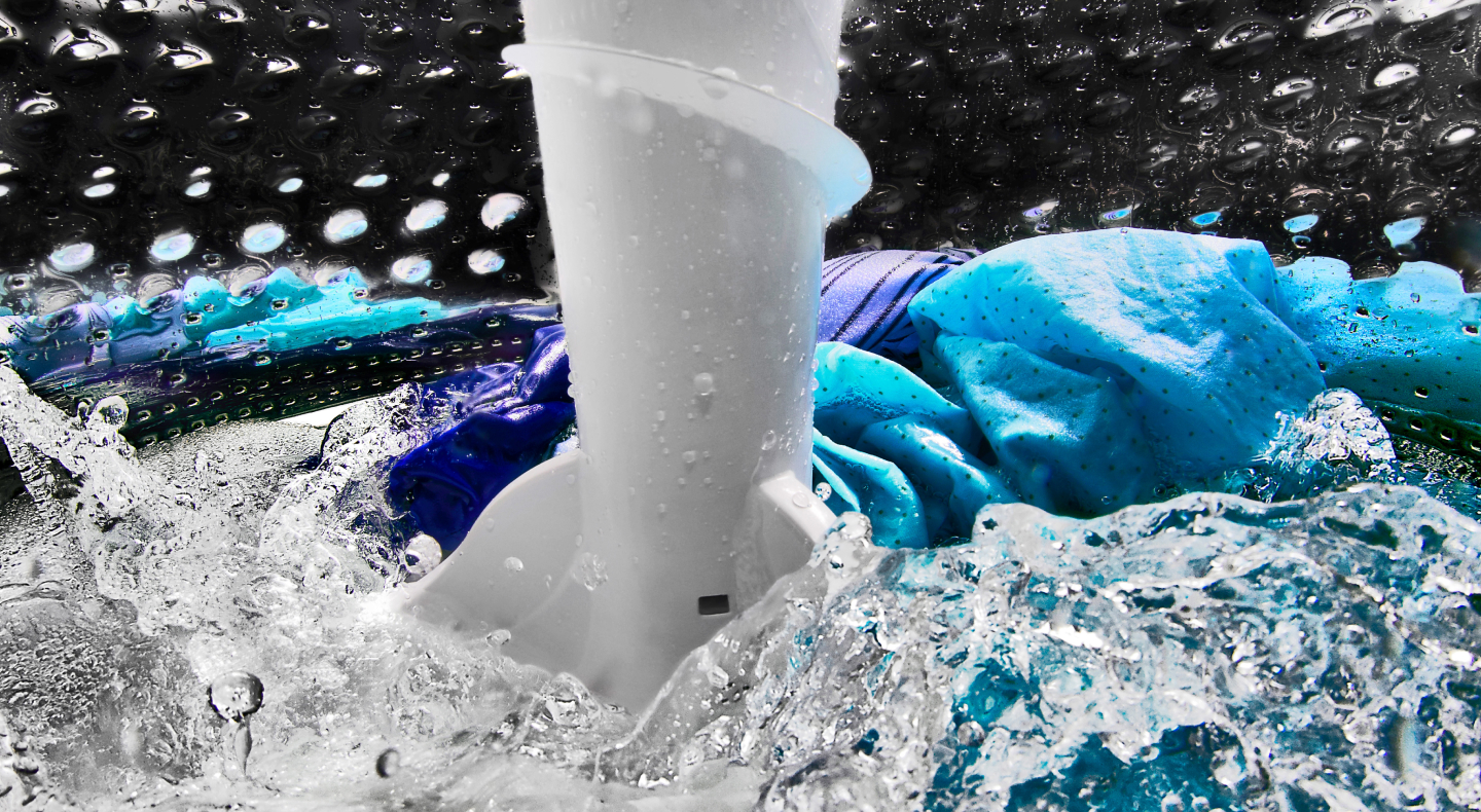 Clothes inside a washing machine with an impeller