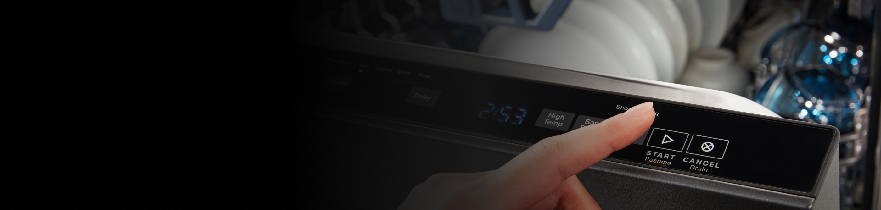 Finger hovering over “Start” button on dishwasher control panel