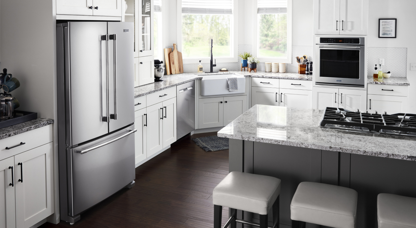 Kitchen with white cabinetry and granite countertops with stainless steel appliances