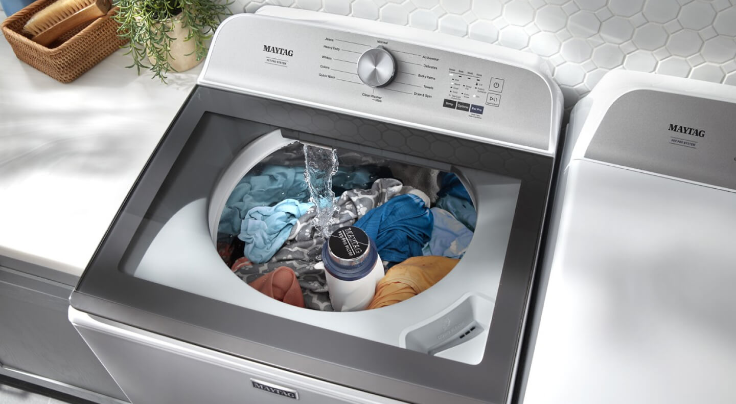 An overhead view of a Maytag® washing machine filling with water