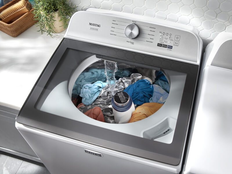 An overhead view of a Maytag® washing machine filling with water