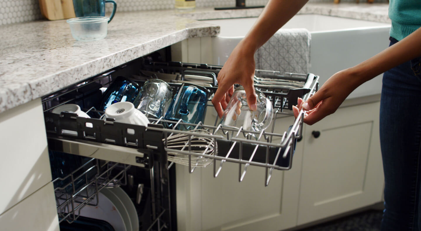 Placing a dirty mug onto the third level rack