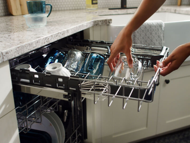 Placing a dirty mug onto the third level rack