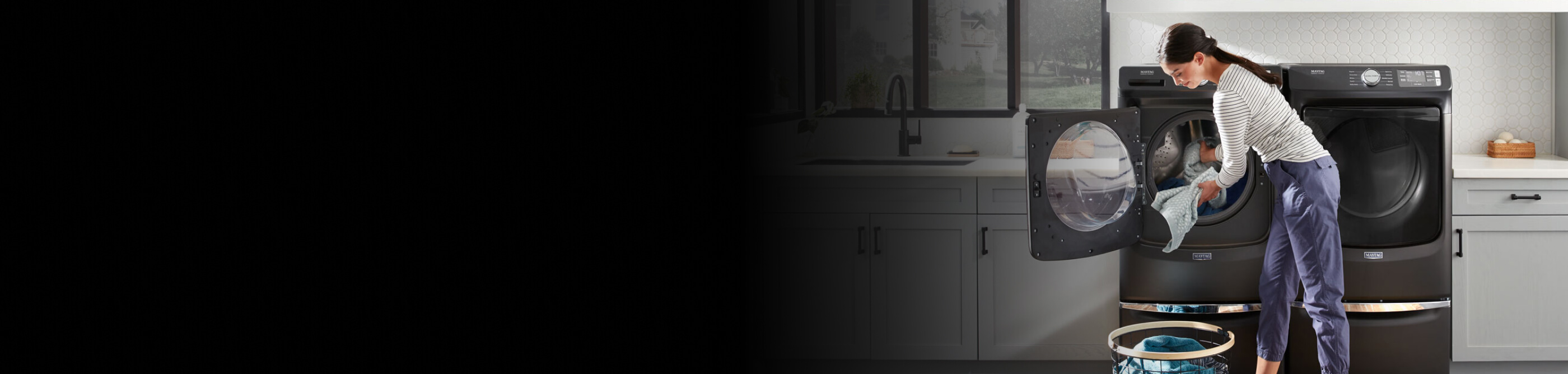 Person doing laundry with a Maytag® washing machine