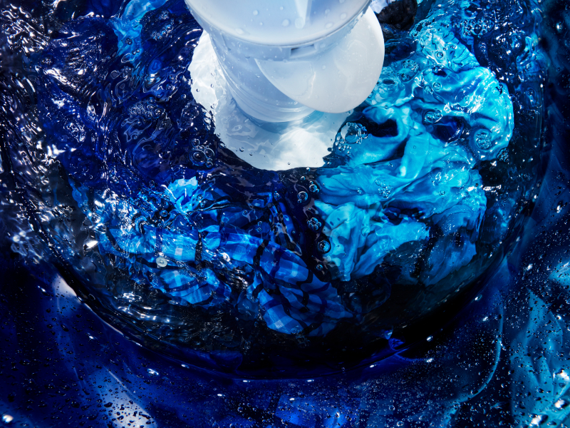 Laundry submerged in water inside a washing machine