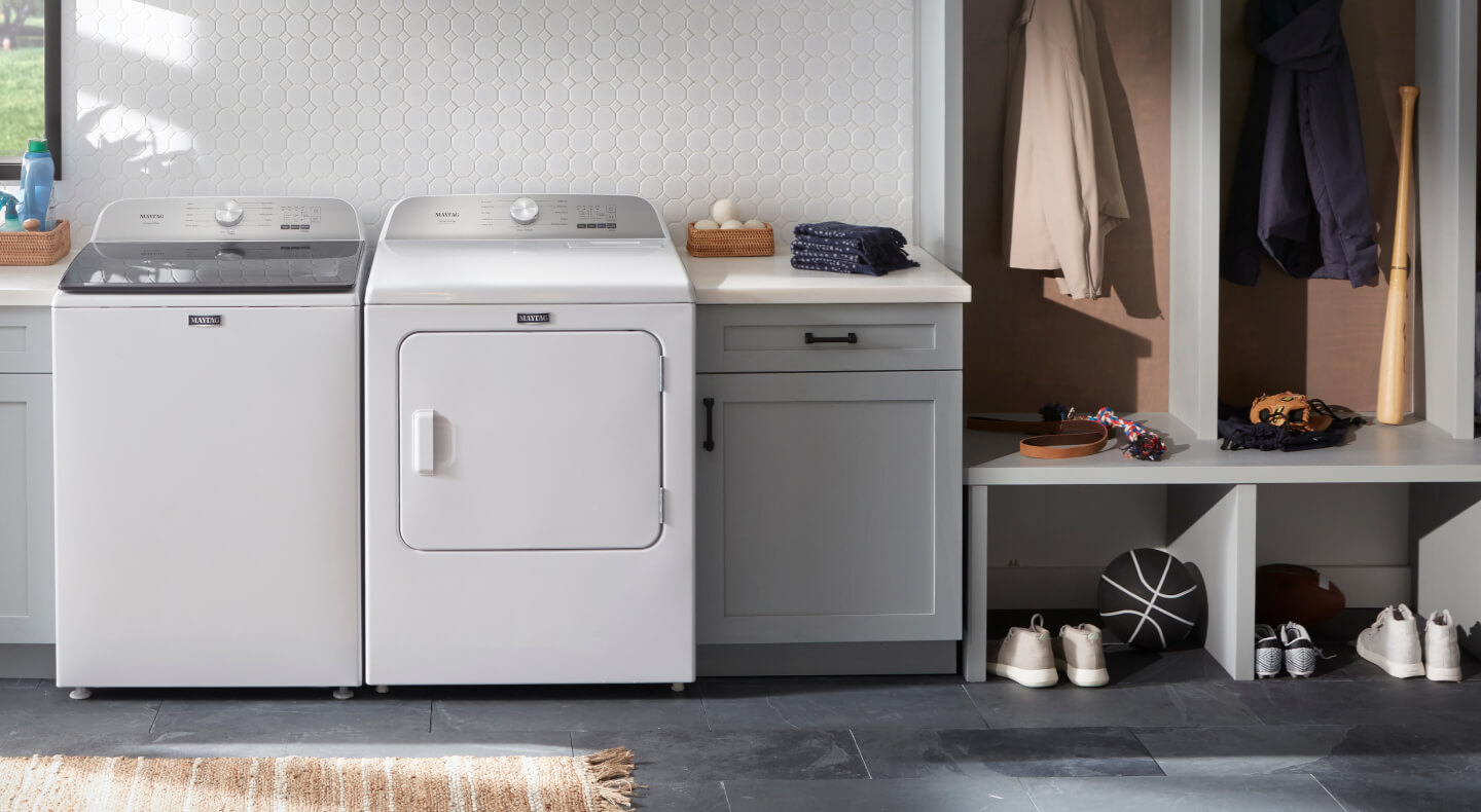 A white Maytag® washer and dryer in a laundry area