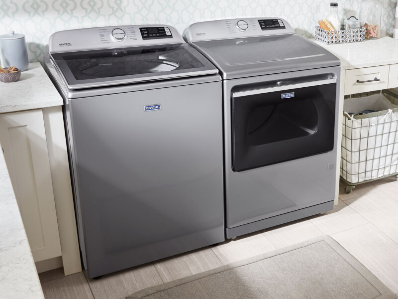 Maytag® top load washer and dryer set in a laundry room