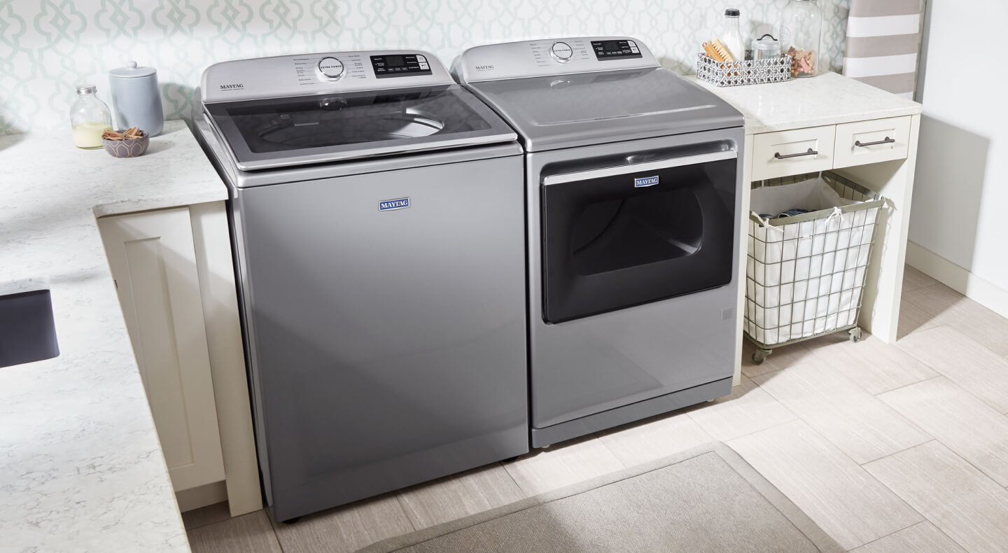 Maytag® top load washer and dryer set in a laundry room