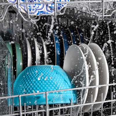 Plates and bowls being washed in a Maytag® dishwasher