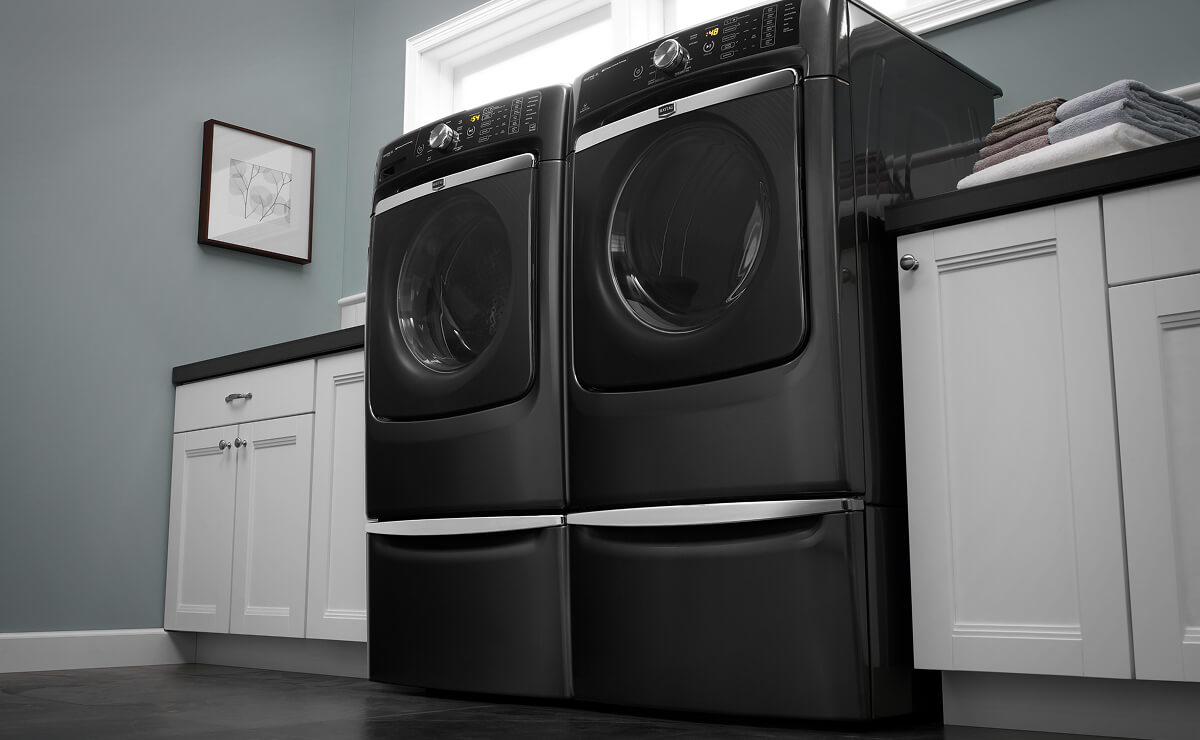 A Maytag® washer and dryer pair in a laundry room
