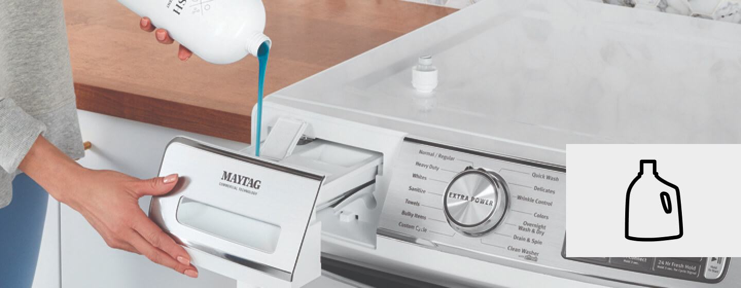 Hand pouring detergent into a detergent dispenser