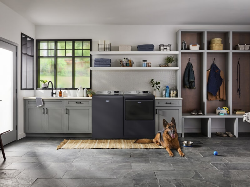Maytag® washer and dryer set in a mudroom with grey cabinets