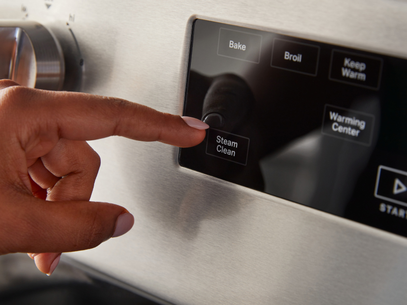 A person selecting a steam clean option