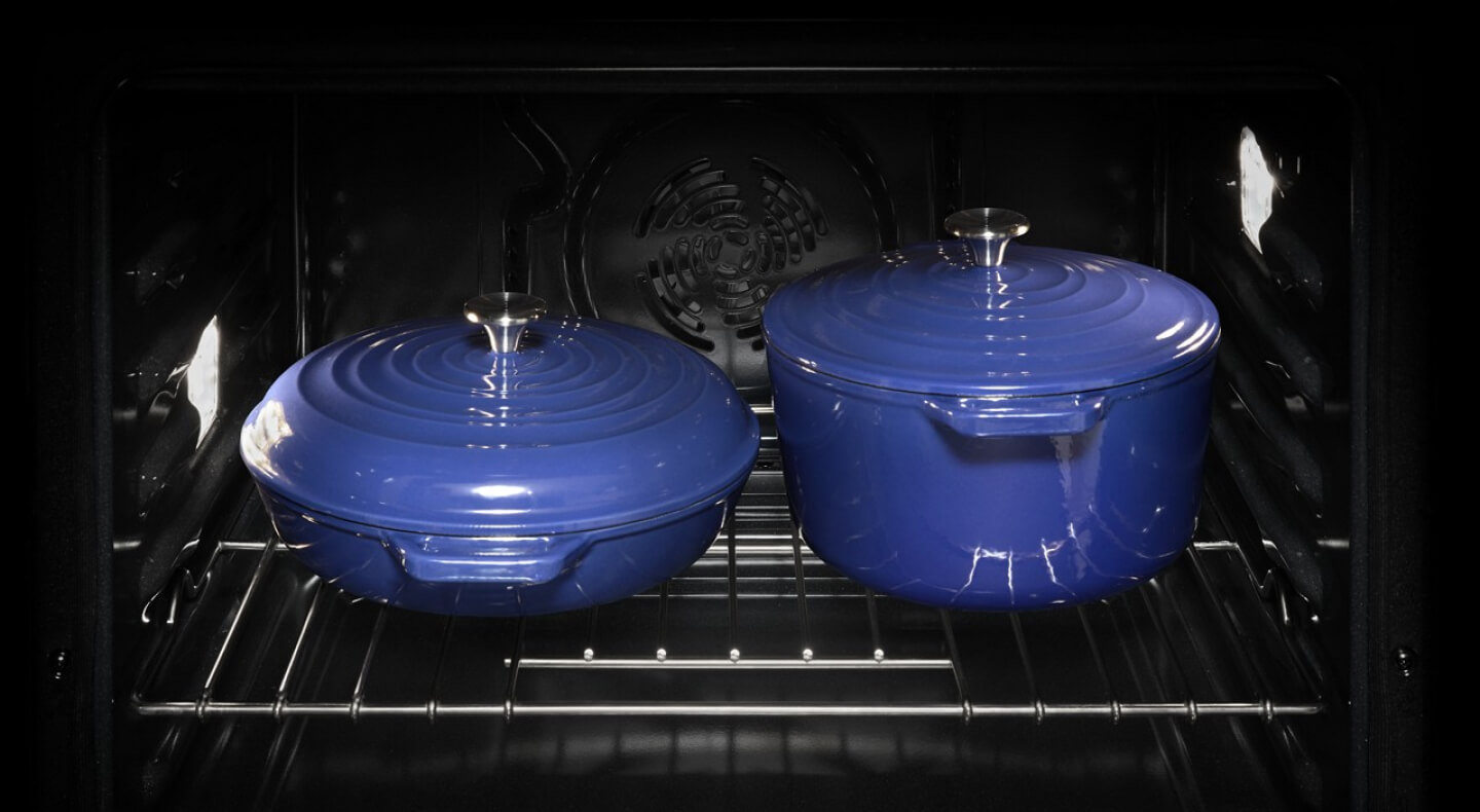 Two blue pots inside an oven