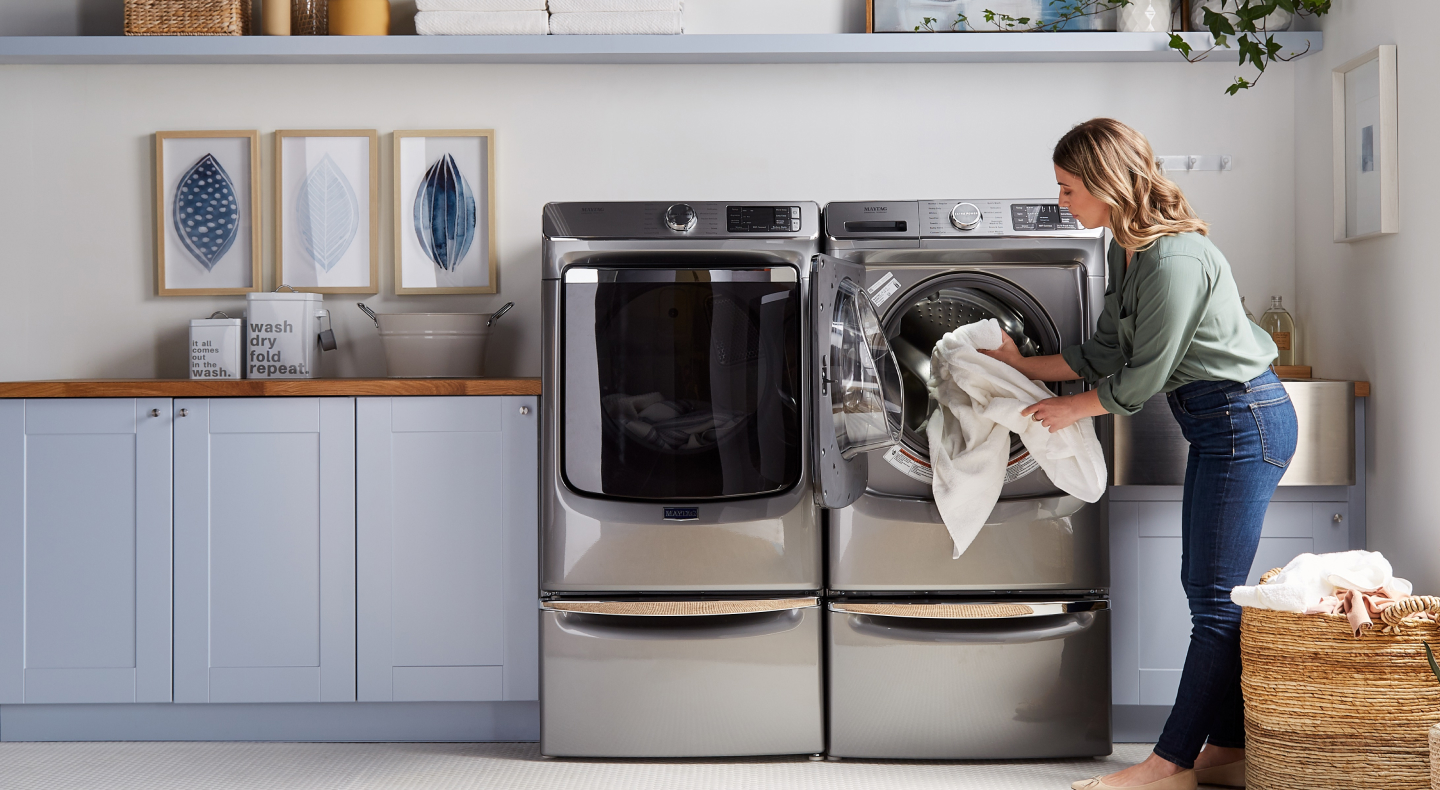 Person unloading laundry from a dryer