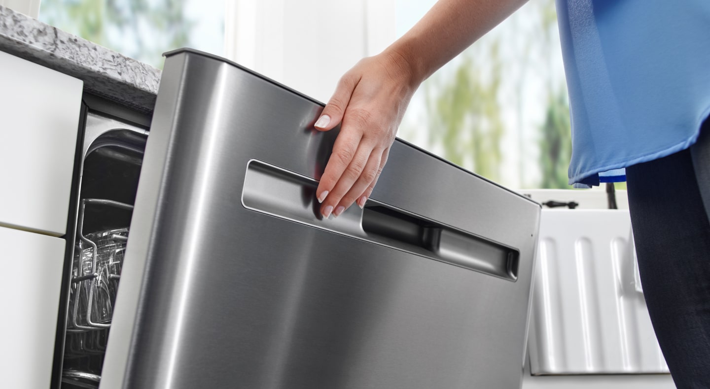 A hand pushing close a washer door