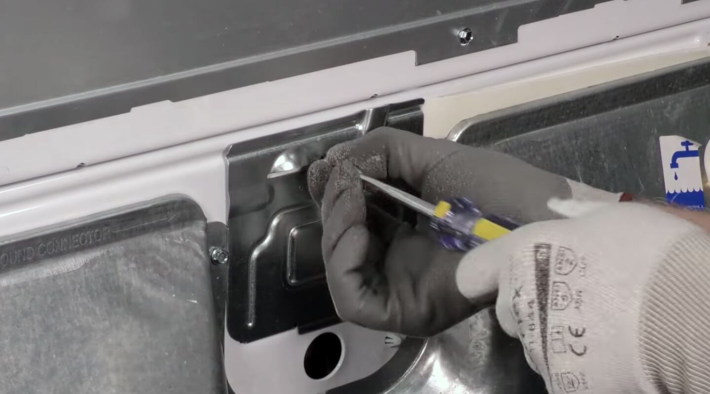 A person unscrewing the terminal plate