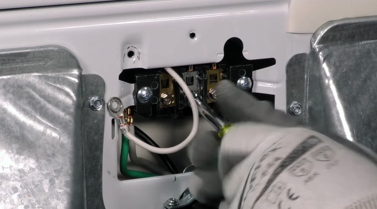 Person disconnecting wires from a dryer