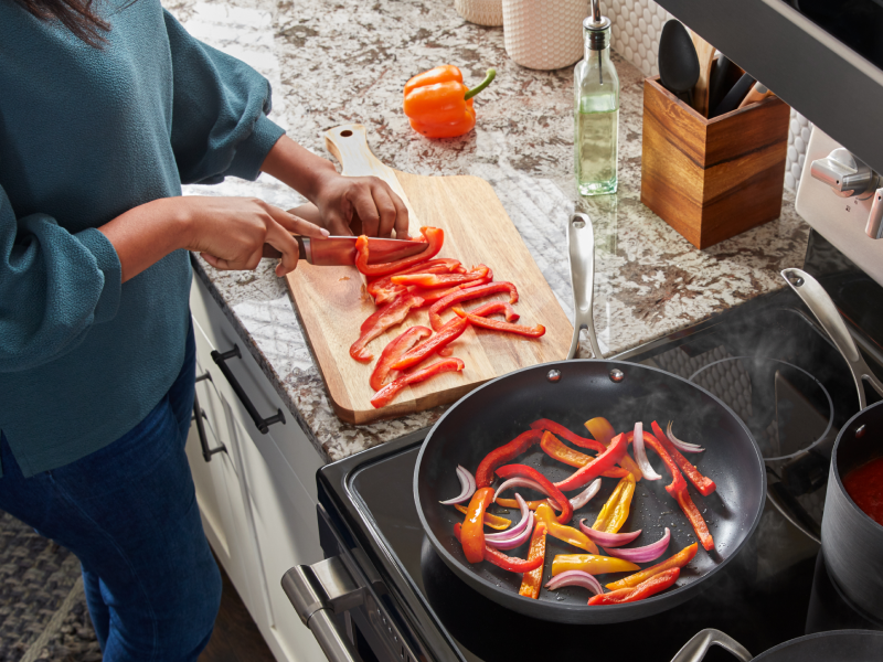 Person slicing peppers on a cutting board