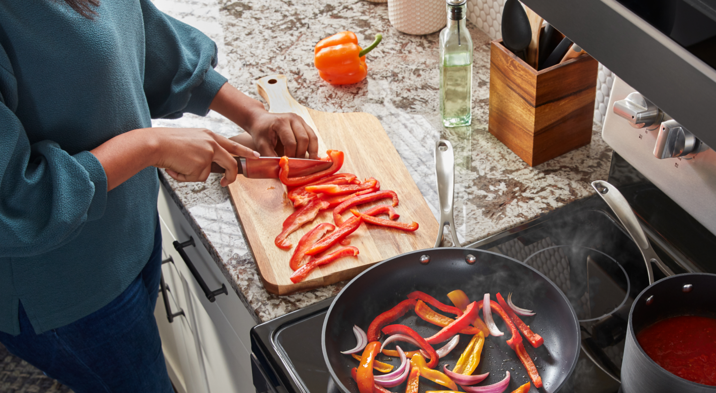 Person slicing peppers on a cutting board